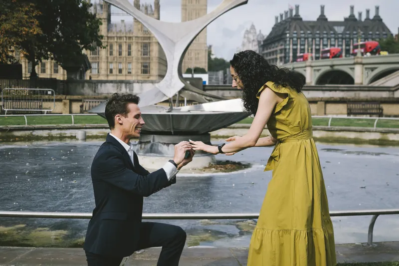 Jake placing the engagement ring on Parmida's finger