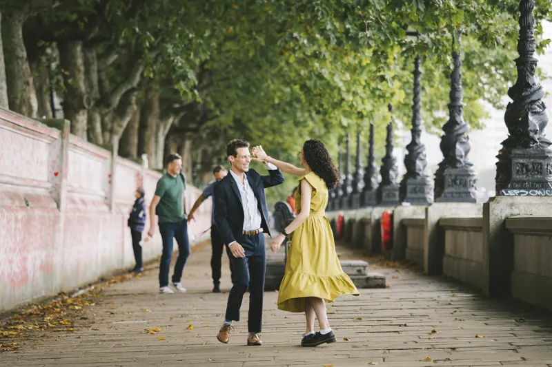 Jake twirling Parmida along the riverside in London
